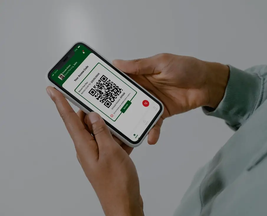A close-up of a security staff member using the Sylogate Staff Application on a smartphone, verifying visitor credentials and monitoring estate access for enhanced security management.