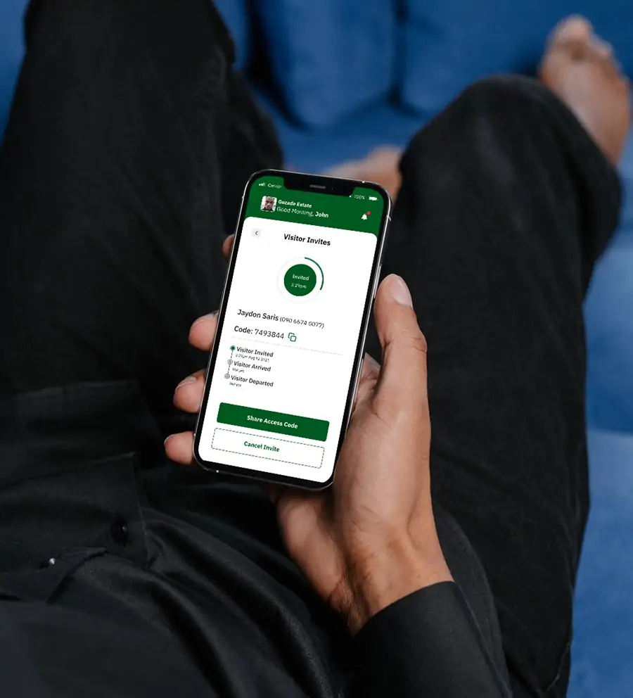 A person holding a smartphone displaying the Sylogate Resident App's visitor invite screen.